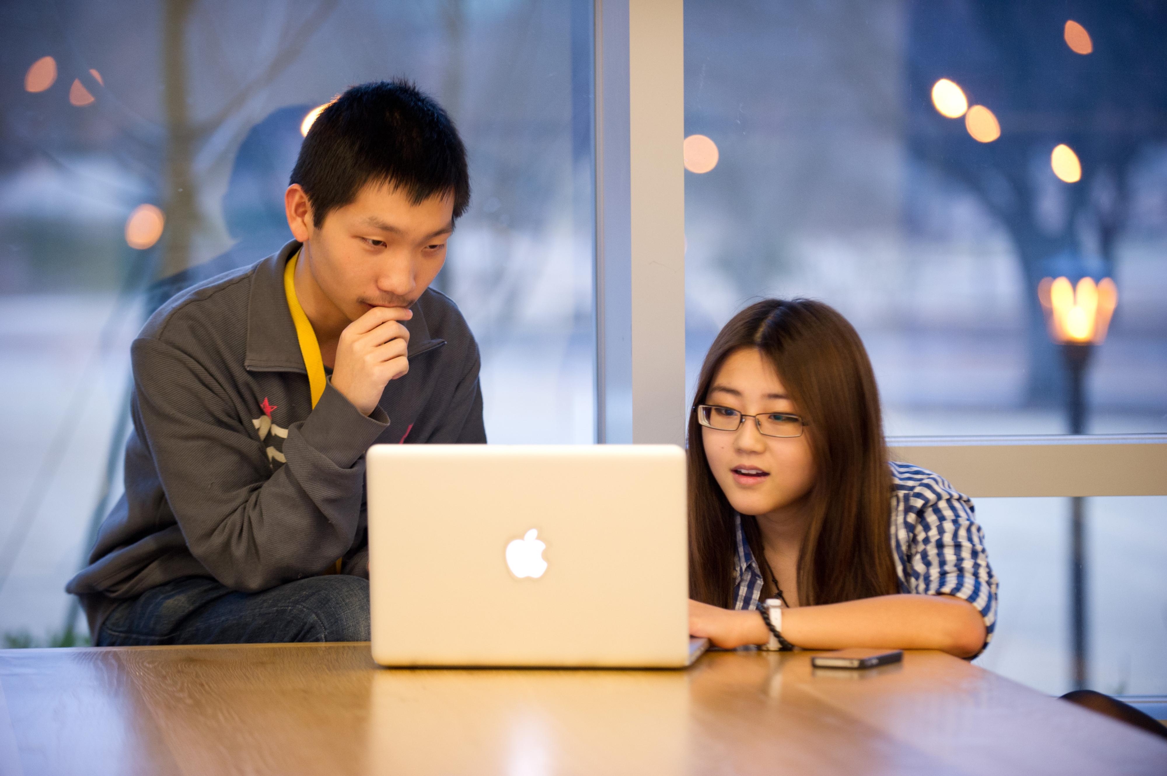 Students solving a problem on a computer